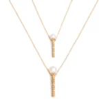 Perla’s gold magic wand necklace 
2